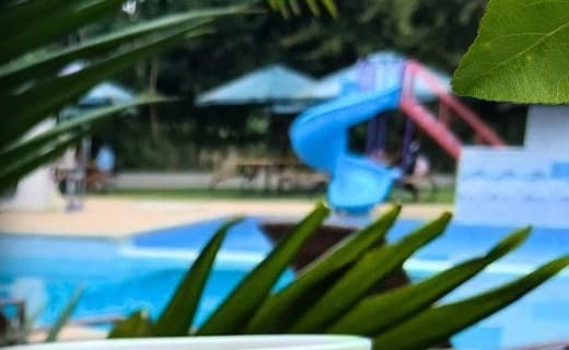 The Kalya pool with its blue water slide and play area